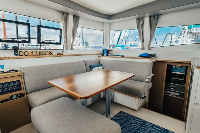 27 Reasons Yacht Photos Pics Modern interior of 2020 Excess 12 catamaran with cozy seating and wooden table.