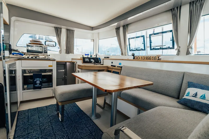 27 Reasons Yacht Photos Pics Interior of 2020 Excess 12 catamaran with modern kitchen and cozy seating area.