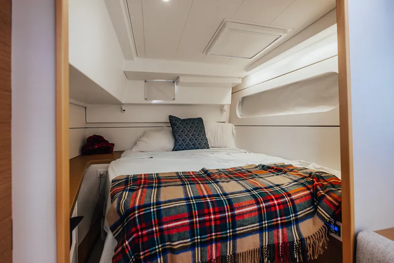 27 Reasons Yacht Photos Pics Cozy cabin interior of 2020 Excess 12 yacht with plaid blanket and pillows.