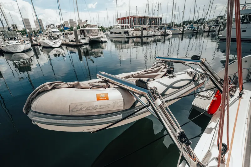 27 Reasons Yacht Photos Pics 2020 Excess 12 boat docked in a marina with surrounding yachts and clear reflections.