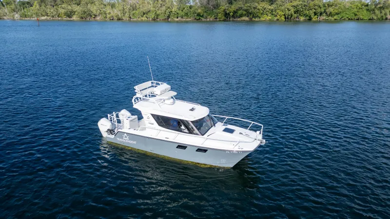 Transcendent Yacht Photos Pics 2023 ArrowCat Flybridge Dual Helm boat on calm blue water.