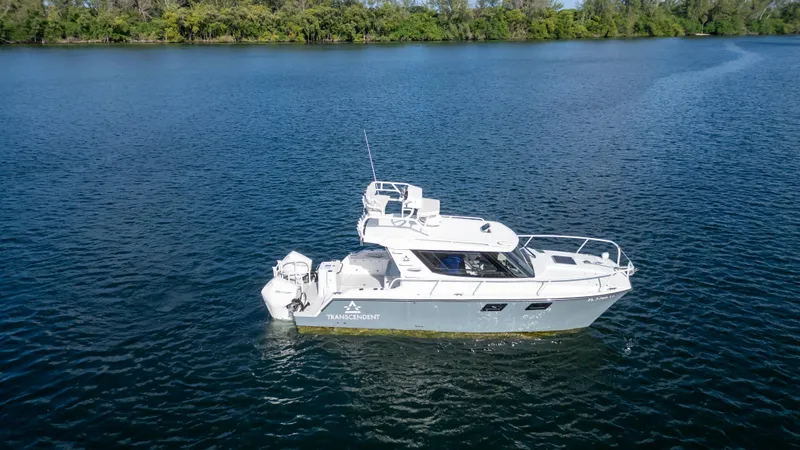 Transcendent Yacht Photos Pics 2023 ArrowCat Flybridge Dual Helm boat on a serene lake.