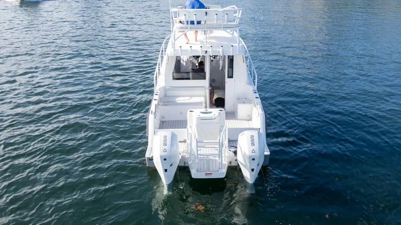 Transcendent Yacht Photos Pics 2023 ArrowCat Flybridge Dual Helm boat on water, rear view.
