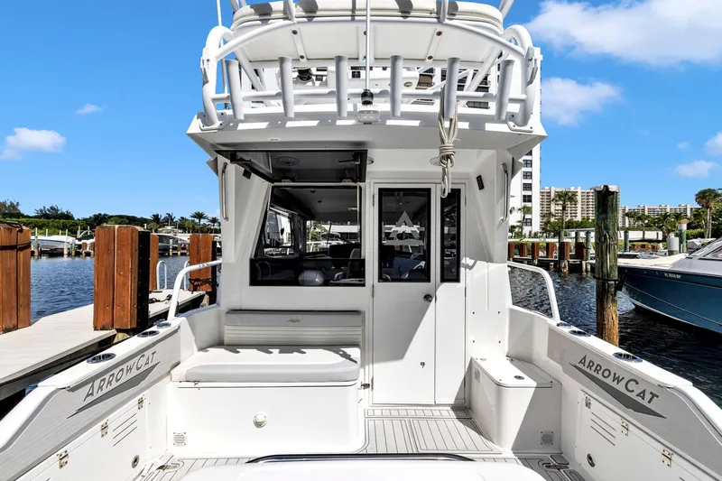 Transcendent Yacht Photos Pics 2023 ArrowCat Flybridge Dual Helm boat docked at marina, showcasing rear deck and seating.