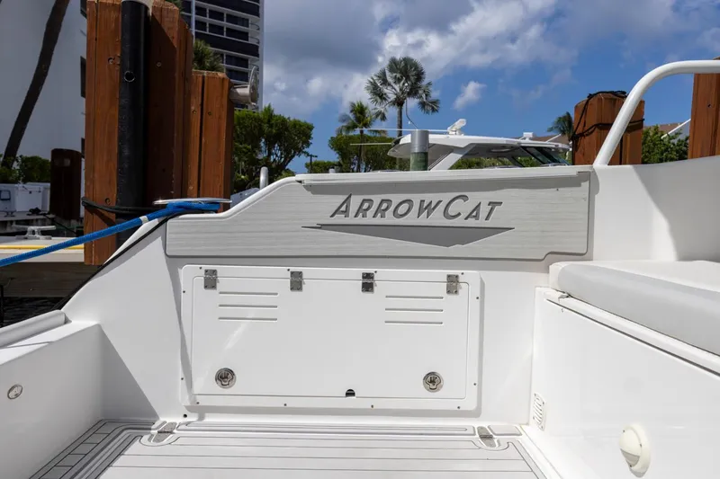 Transcendent Yacht Photos Pics 2023 ArrowCat Flybridge Dual Helm boat docked, showcasing sleek design and branding.