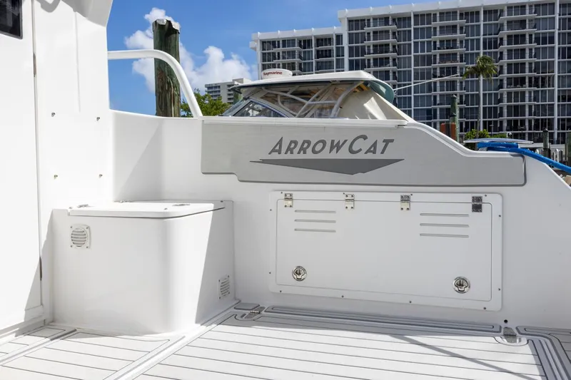 Transcendent Yacht Photos Pics 2023 ArrowCat Flybridge Dual Helm boat docked near modern buildings.