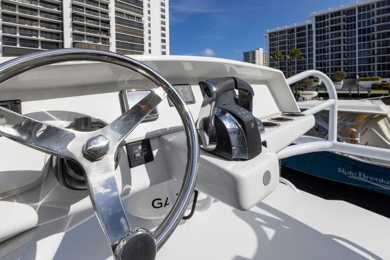 Transcendent Yacht Photos Pics 2023 ArrowCat Flybridge Dual Helm with cityscape background.