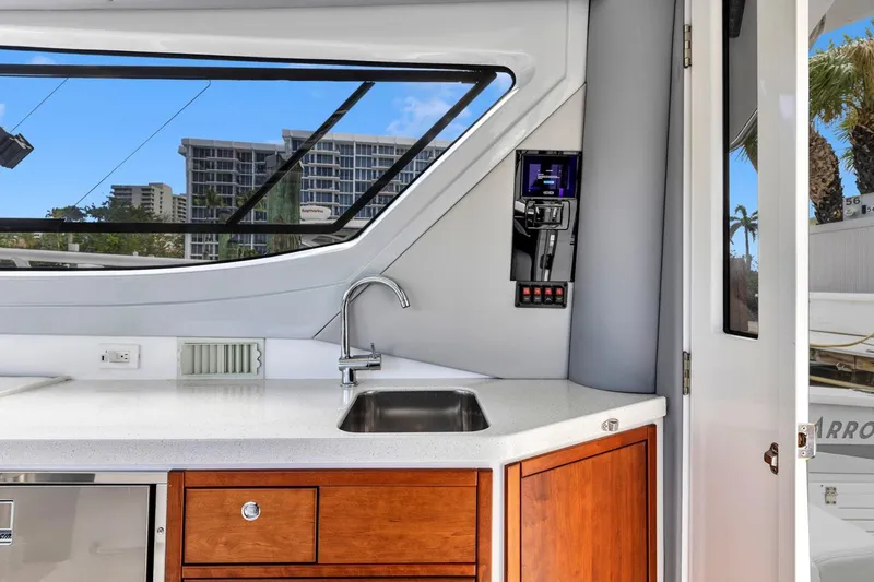 Transcendent Yacht Photos Pics Modern kitchen area on 2023 ArrowCat Flybridge Dual Helm yacht with sleek design and city view.