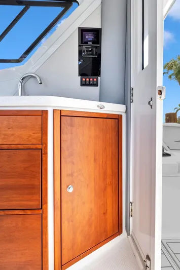 Transcendent Yacht Photos Pics 2023 ArrowCat Flybridge Dual Helm interior with wooden cabinetry and modern controls.