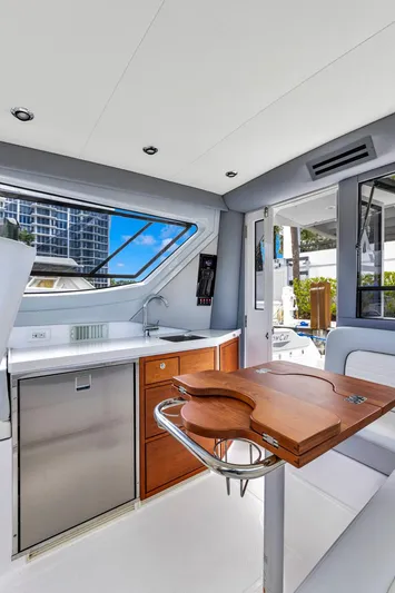 Transcendent Yacht Photos Pics Interior of 2023 ArrowCat Flybridge Dual Helm yacht with modern kitchen and seating area.