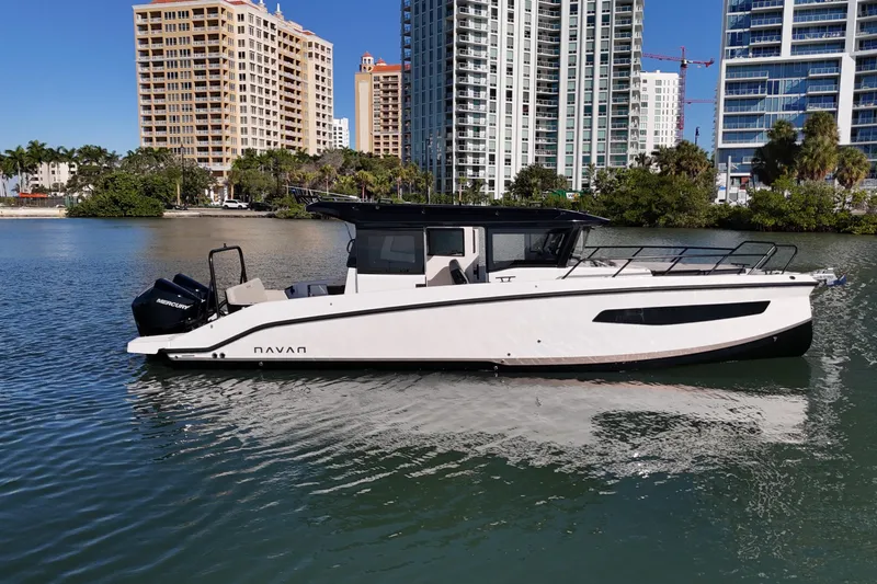  Yacht Photos Pics 2026 Navan C30 boat on water with city skyline background.