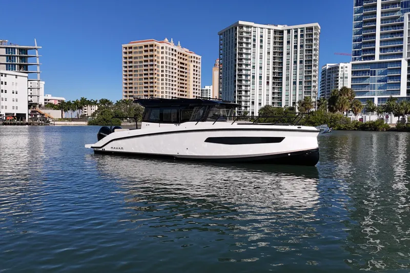  Yacht Photos Pics Navan C30 2026 boat on water, urban skyline background, sunny day.