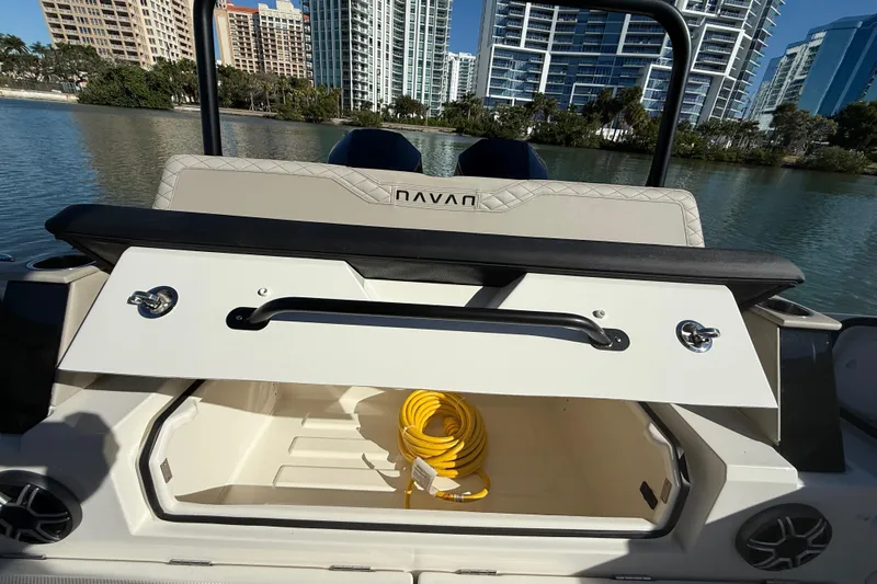  Yacht Photos Pics 2026 Navan C30 boat storage compartment open, revealing a yellow rope, with cityscape background.