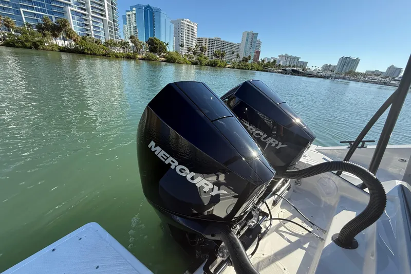  Yacht Photos Pics Twin Mercury outboard engines on a Navan C30 boat, 2026 model, in a scenic waterfront setting.