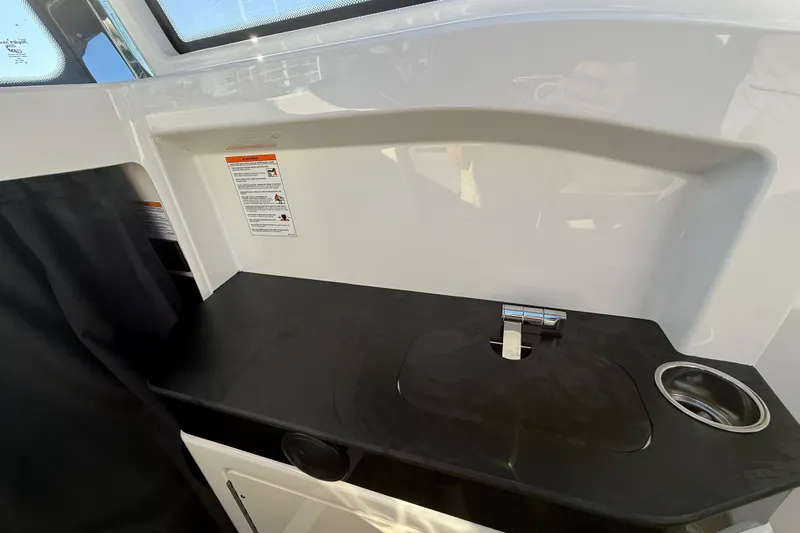  Yacht Photos Pics Interior of 2026 Navan C30 boat featuring a sleek black countertop and modern faucet.