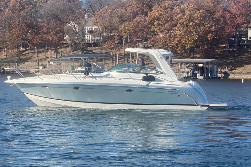  Yacht Photos Pics 2005 Formula 40 Performance Cruiser on a serene lake with autumn trees in the background.