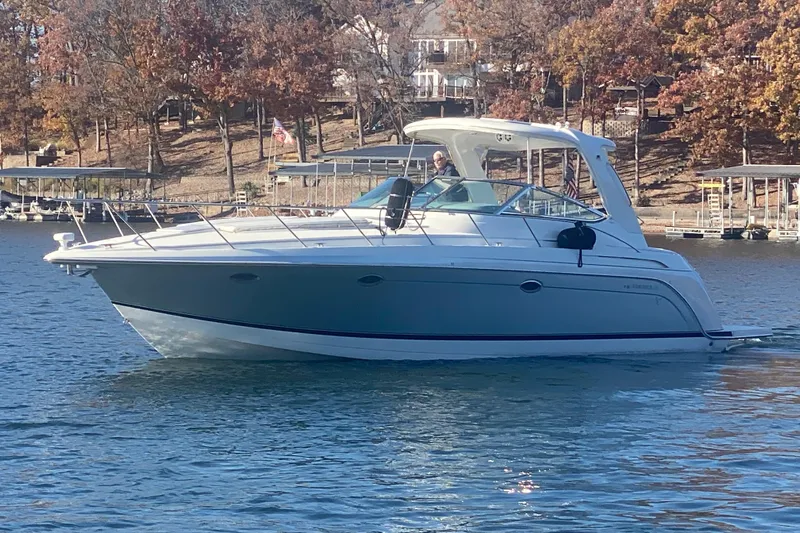  Yacht Photos Pics 2005 Formula 40 Performance Cruiser on a serene lake with autumn trees in the background.