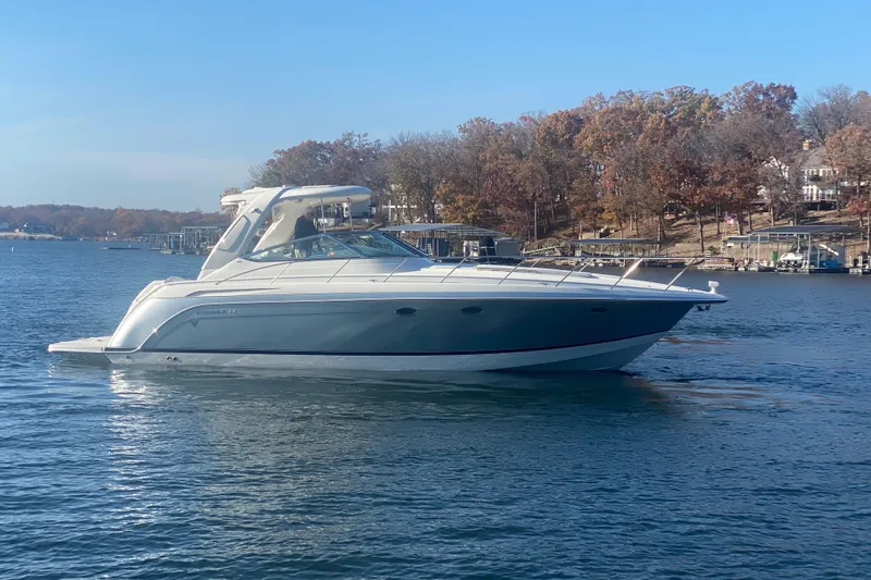  Yacht Photos Pics 2005 Formula 40 Performance Cruiser on a serene lake with autumn trees in the background.