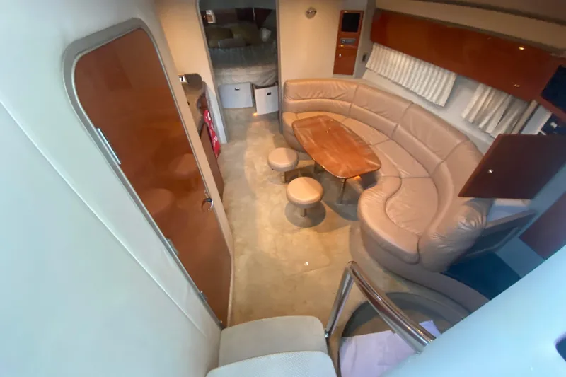  Yacht Photos Pics 2005 Formula 40 Performance Cruiser interior with curved seating and wooden table.