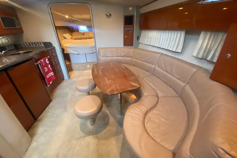  Yacht Photos Pics Luxurious interior of a 2005 Formula 40 Performance Cruiser with curved seating and wooden table.