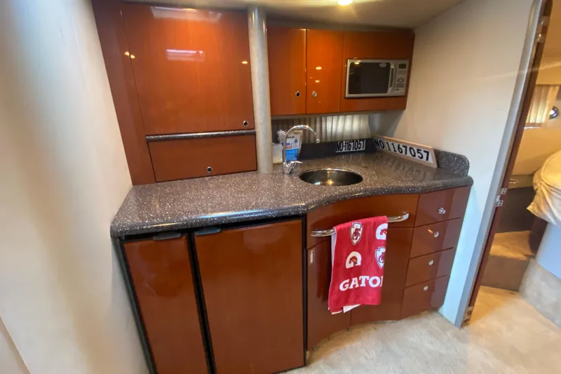  Yacht Photos Pics 2005 Formula 40 Performance Cruiser kitchen with wood cabinets and granite countertop.