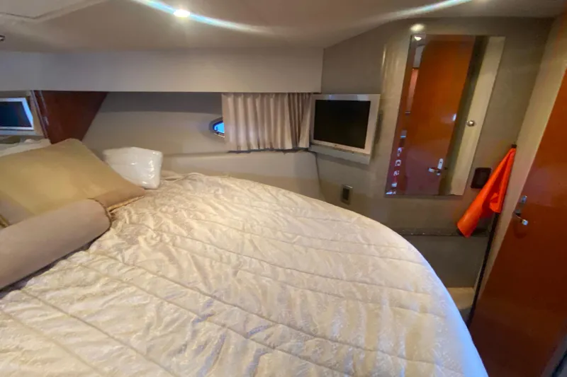  Yacht Photos Pics Interior of 2005 Formula 40 Performance Cruiser with bed, TV, and porthole window.