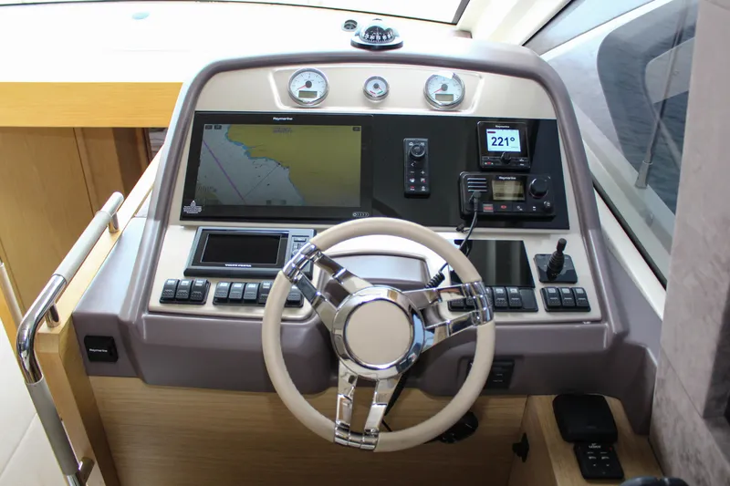 Oxygen Yacht Photos Pics Helm of 2016 Beneteau Monte Carlo 5 yacht with navigation controls and steering wheel.