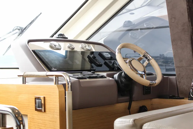 Oxygen Yacht Photos Pics Helm of 2016 Beneteau Monte Carlo 5 yacht with modern controls and steering wheel.