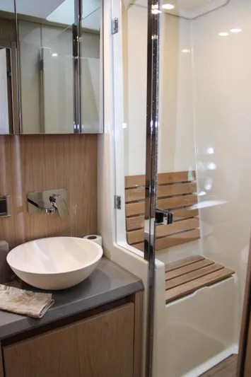 Oxygen Yacht Photos Pics Luxurious bathroom in 2016 Beneteau Monte Carlo 5 yacht with modern fixtures and wooden accents.