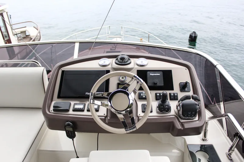 Oxygen Yacht Photos Pics 2016 Beneteau Monte Carlo 5 helm with modern navigation equipment and steering wheel.