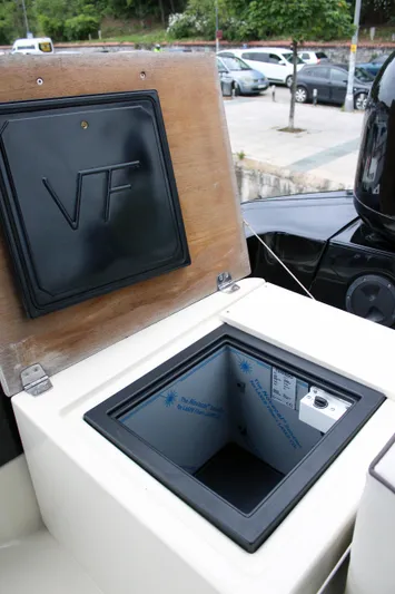 Oxygen Yacht Photos Pics Beneteau Monte Carlo 5 (2016) yacht storage compartment with open lid, parked cars in background.