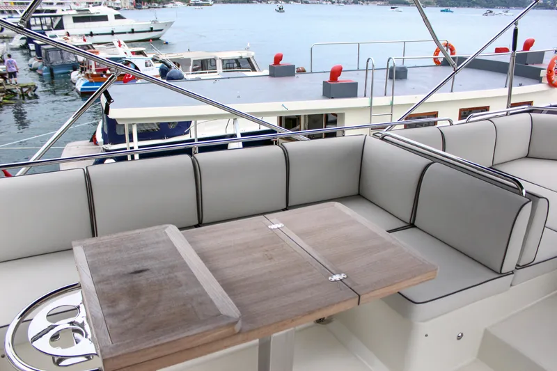Oxygen Yacht Photos Pics 2016 Beneteau Monte Carlo 5 yacht with elegant seating and wooden table on deck.