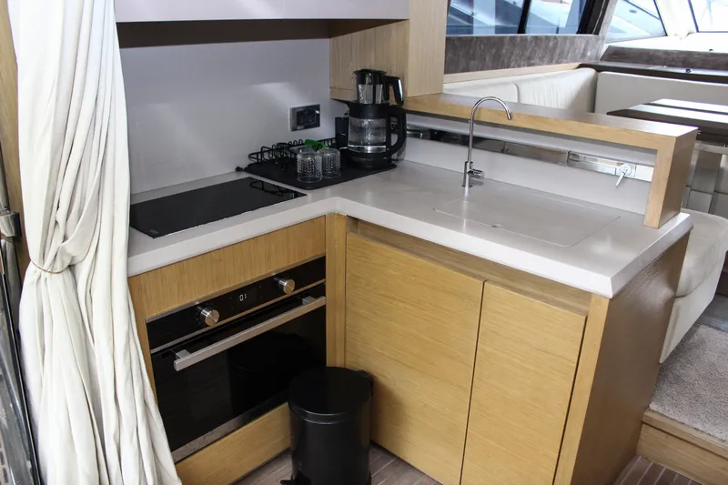 Oxygen Yacht Photos Pics Modern kitchen in 2016 Beneteau Monte Carlo 5 yacht with stove, sink, and coffee maker.