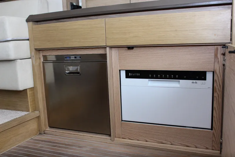 Oxygen Yacht Photos Pics 2016 Beneteau Monte Carlo 5 kitchen with built-in appliances and wooden cabinetry.