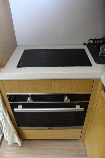 Oxygen Yacht Photos Pics Modern kitchen in 2016 Beneteau Monte Carlo 5 yacht with sleek stovetop and oven.