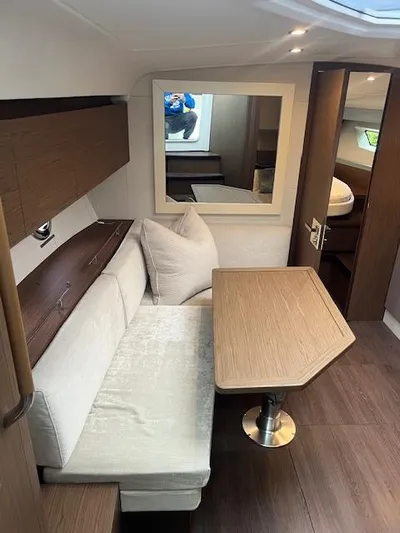  Yacht Photos Pics 2019 Beneteau Gran Turismo 40 interior with modern seating and wooden table.