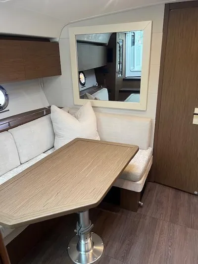  Yacht Photos Pics Interior of 2019 Beneteau Gran Turismo 40, featuring a cozy dining area with wood accents.