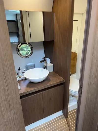  Yacht Photos Pics 2019 Beneteau Gran Turismo 40 bathroom with modern sink and wooden cabinetry.