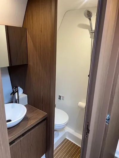  Yacht Photos Pics 2019 Beneteau Gran Turismo 40 bathroom with modern sink, toilet, and shower.