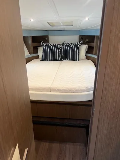  Yacht Photos Pics 2019 Beneteau Gran Turismo 40 cabin with cozy bed and striped pillows.