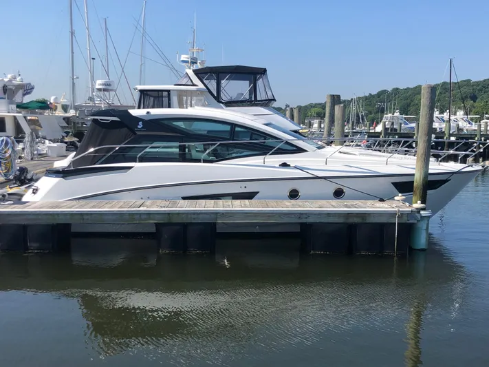  Yacht Photos Pics 2019 Beneteau Gran Turismo 41 yacht docked at marina, side view.