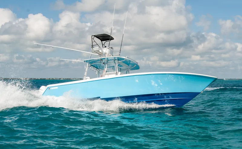 + Sea Keeper Yacht Photos Pics 2019 Contender 39 ST boat cruising on open ocean under cloudy sky.