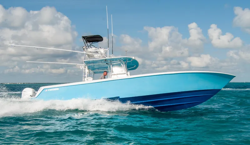 + Sea Keeper Yacht Photos Pics 2019 Contender 39 ST boat cruising on ocean with blue sky background.