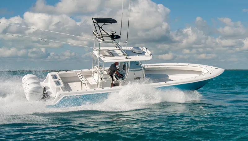 + Sea Keeper Yacht Photos Pics 2019 Contender 39 ST boat cruising on open water under a cloudy sky.