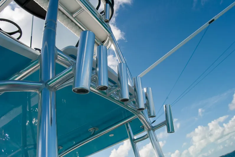 + Sea Keeper Yacht Photos Pics 2019 Contender 39 ST boat with stainless steel rod holders against a blue sky.