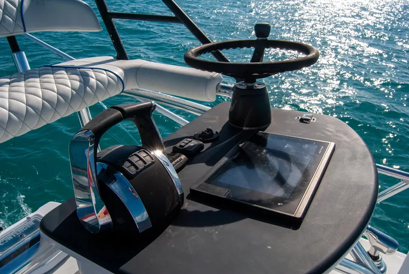 + Sea Keeper Yacht Photos Pics 2019 Contender 39 ST boat helm with steering wheel and throttle on open water.
