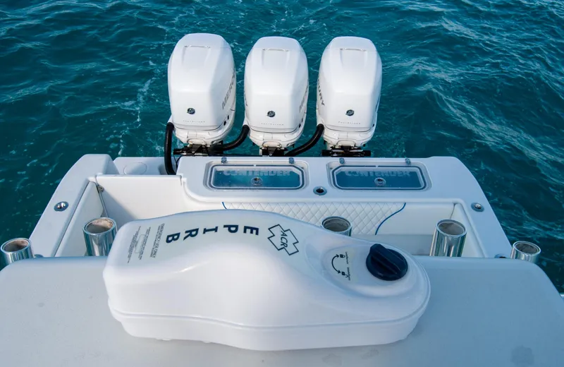 + Sea Keeper Yacht Photos Pics 2019 Contender 39 ST boat with triple outboard engines on blue water.