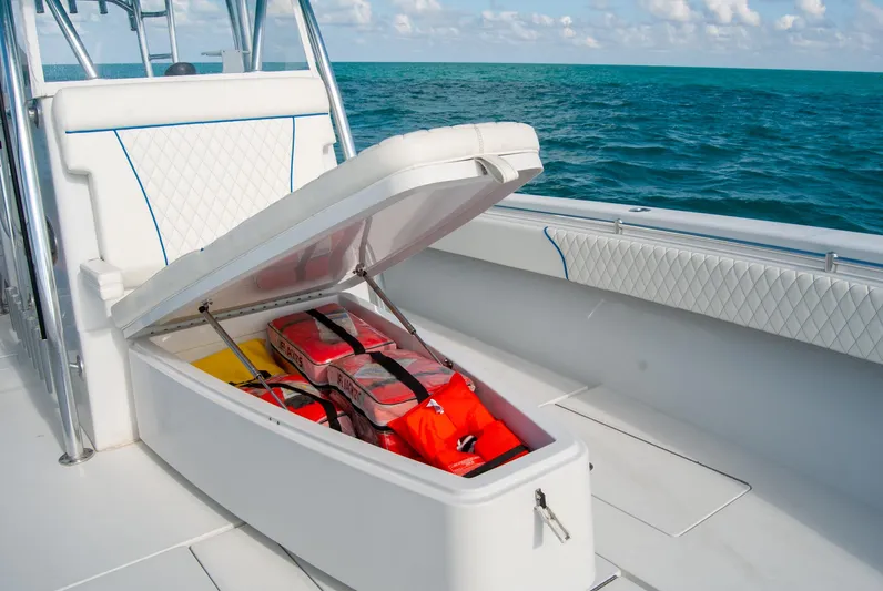 + Sea Keeper Yacht Photos Pics 2019 Contender 39 ST boat with open storage compartment, life jackets visible, on the ocean.