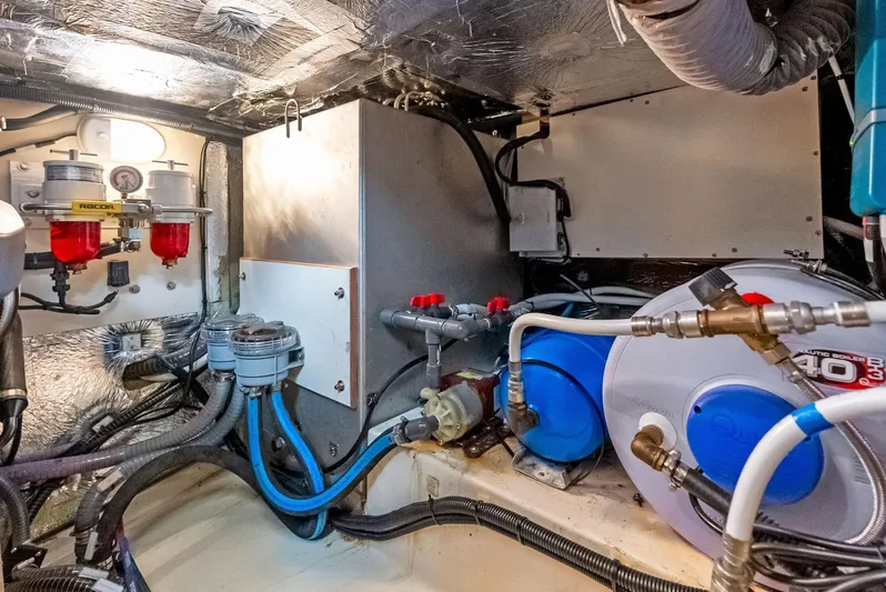 Southwind Yacht Photos Pics Engine room of a 2021 Moody 45 DS yacht with various mechanical components.