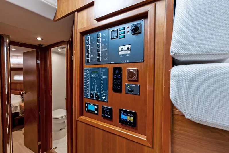 Southwind Yacht Photos Pics Control panel inside a 2021 Moody 45 DS yacht with wooden interior.